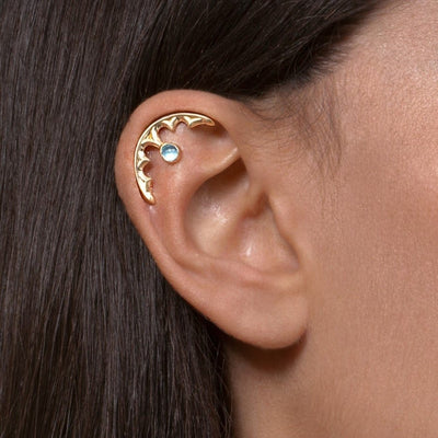 gold gothic cartilage piercing with blue topaz